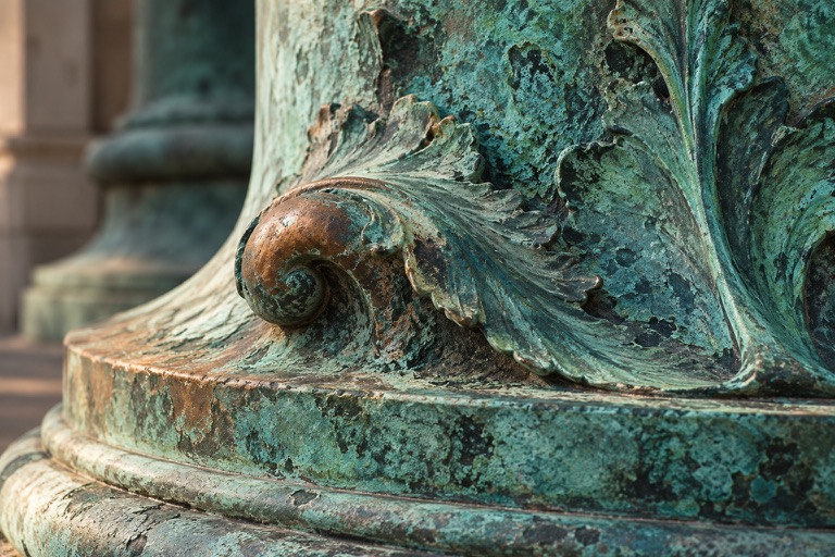 Artistic close view of a copper surface with green and brown patina.